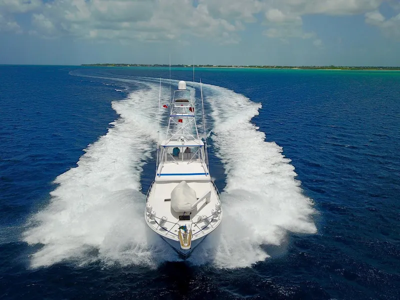 Slide: The Image of 1981 Bertram Convertible yacht cruising on open blue water. - 10