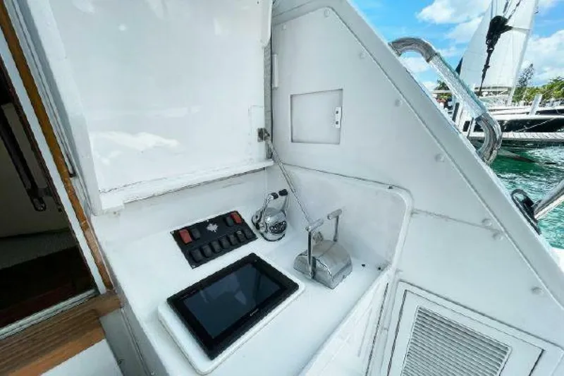 Slide: The Image of Control panel on 1981 Bertram Convertible boat with tablet and switches. - 25
