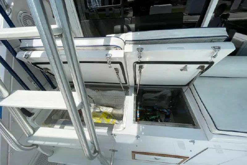 Slide: The Image of 1981 Bertram Convertible boat with open storage compartments on deck. - 26