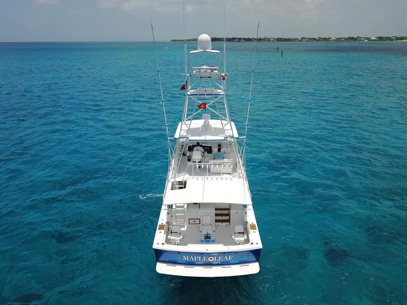 Slide: The Image of 1981 Bertram Convertible yacht Maple Leaf cruising in clear blue ocean waters. - 3