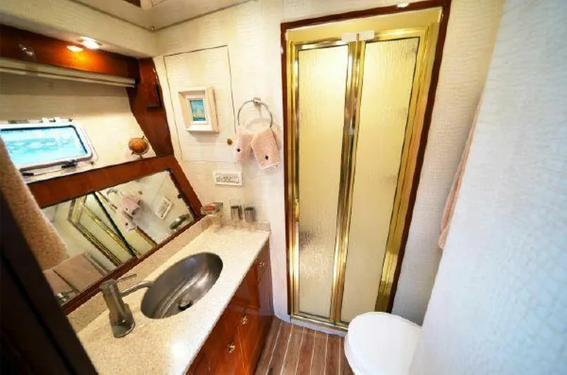 Slide: The Image of 1981 Bertram Convertible yacht bathroom with sink, mirror, and shower. - 37