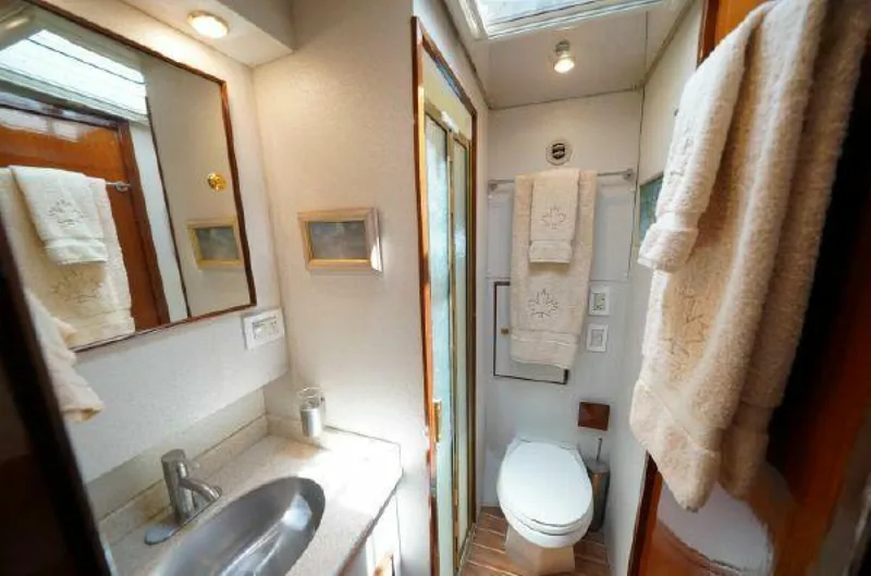 Slide: The Image of 1981 Bertram Convertible yacht bathroom with sink, toilet, and towels. - 39