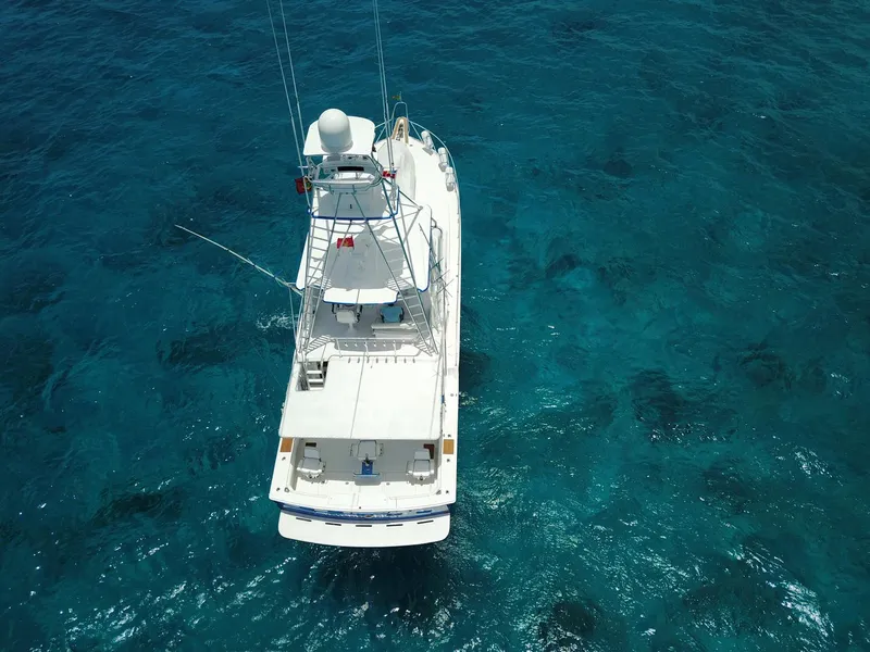 Slide: The Image of Aerial view of a 1981 Bertram Convertible boat on clear blue water. - 4