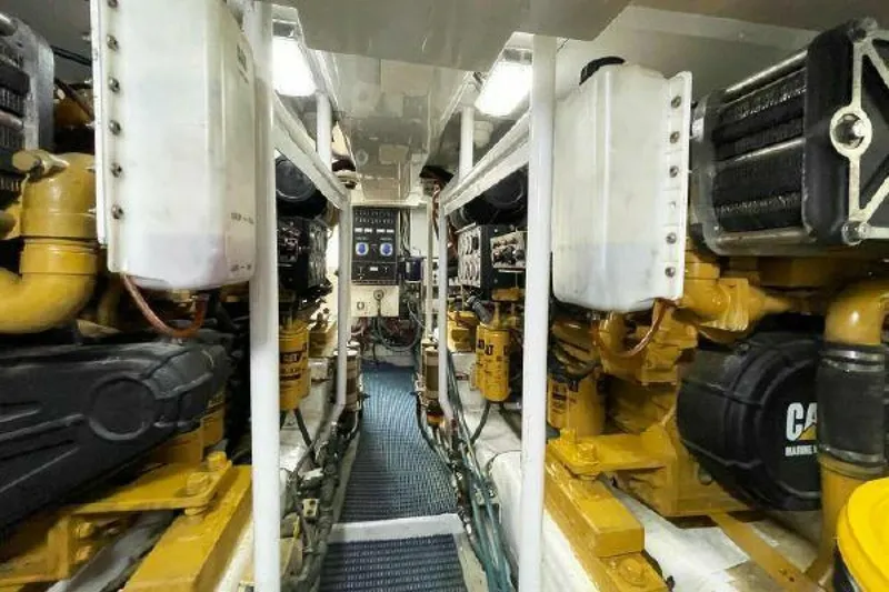 Slide: The Image of 1981 Bertram Convertible engine room with dual Caterpillar engines. - 42