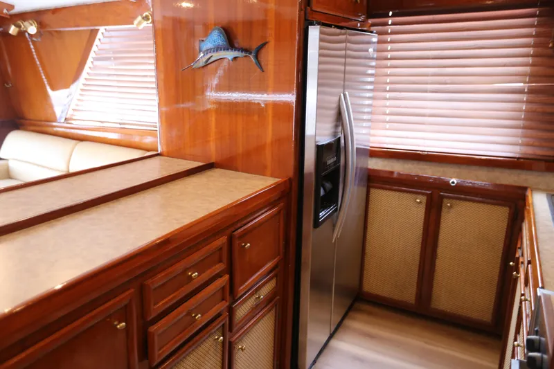 Slide: The Image of 1981 Bertram Convertible yacht interior with wooden cabinetry and stainless steel refrigerator. - 45