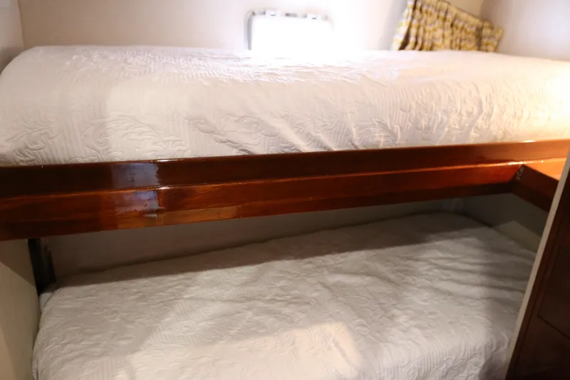 Slide: The Image of Bunk beds in a 1981 Bertram Convertible yacht cabin with white bedding. - 53