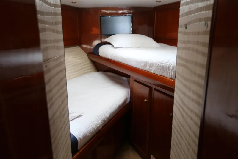 Slide: The Image of 1981 Bertram Convertible cabin with wooden interior and twin beds. - 54