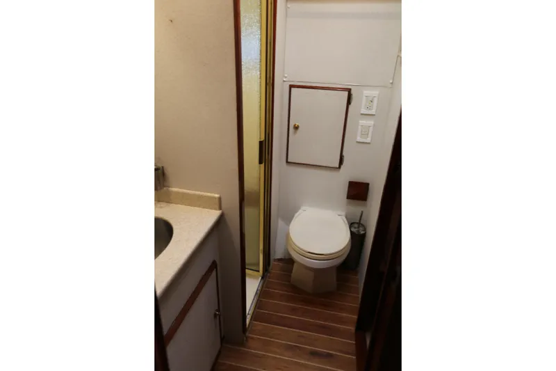 Slide: The Image of 1981 Bertram Convertible yacht bathroom with wooden flooring and compact design. - 59