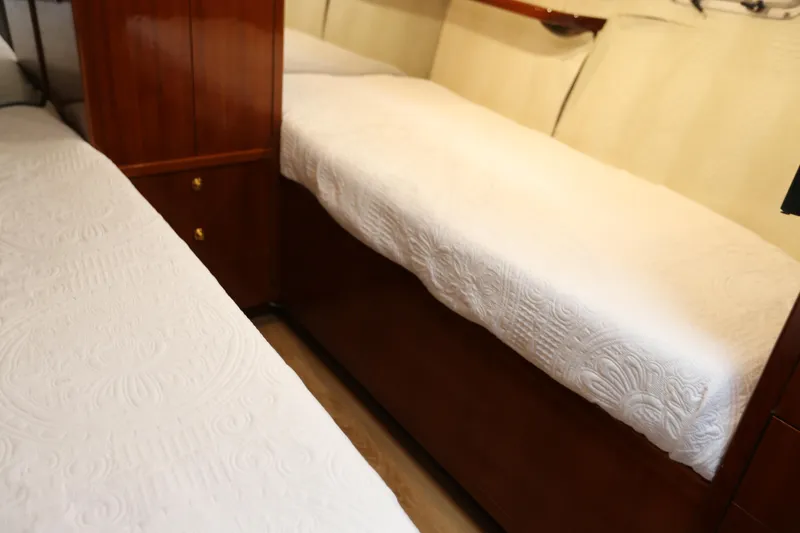 Slide: The Image of 1981 Bertram Convertible interior with twin beds and wooden cabinetry. - 62