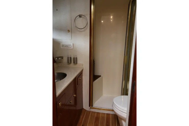 Slide: The Image of Bathroom interior of 1981 Bertram Convertible yacht with shower and sink. - 64