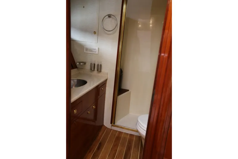 Slide: The Image of 1981 Bertram Convertible yacht bathroom with wood accents and modern fixtures. - 65