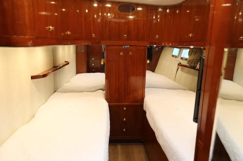 Slide: The Image of Luxurious 1981 Bertram Convertible yacht cabin with twin beds and polished wood finish. - 67