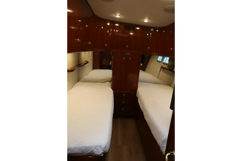 Slide: The Image of Interior of 1981 Bertram Convertible yacht with twin beds and wooden cabinetry. - 68