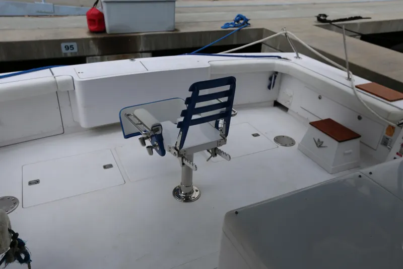 Slide: The Image of 1981 Bertram Convertible boat deck with fishing chair and storage compartments. - 69