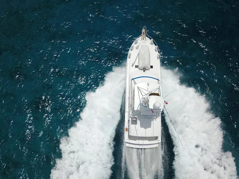 Slide: The Image of Aerial view of a 1981 Bertram Convertible boat cruising on blue ocean water. - 7