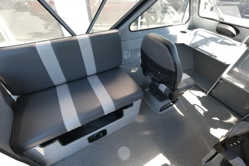Slide: The Image of Interior of a 2019 Hewescraft 200 ProV boat with seating and helm. - 10