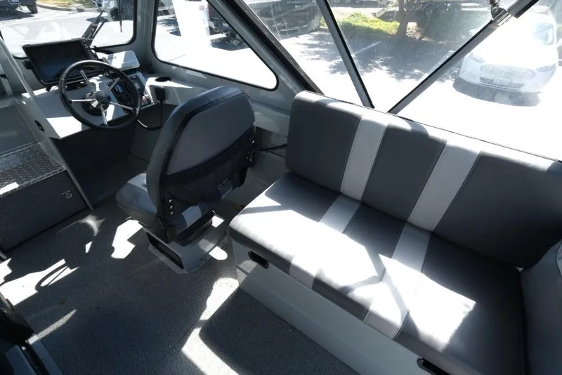Slide: The Image of 2019 Hewescraft 200 ProV interior with steering wheel and seating area. - 11