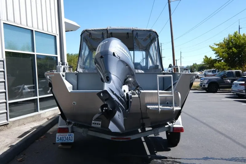 Slide: The Image of 2019 Hewescraft 200 ProV boat with outboard motor, parked outdoors. - 5