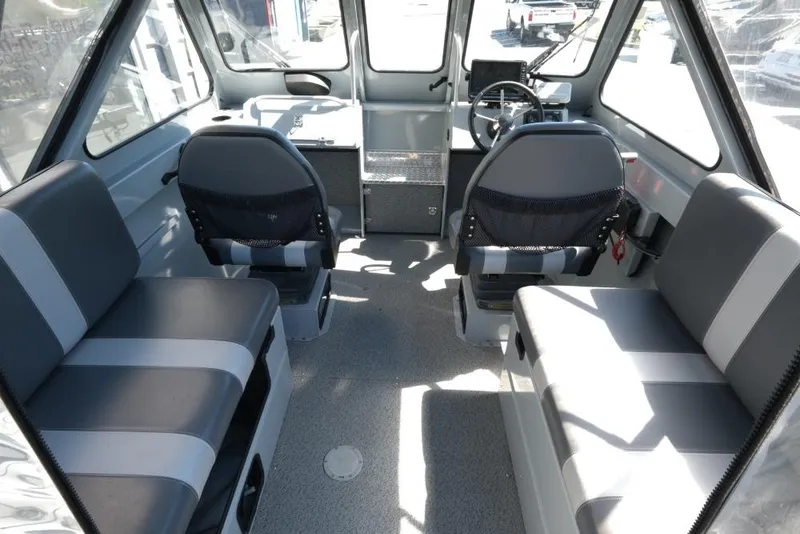 Slide: The Image of Interior of a 2019 Hewescraft 200 ProV boat with seating and steering console. - 9