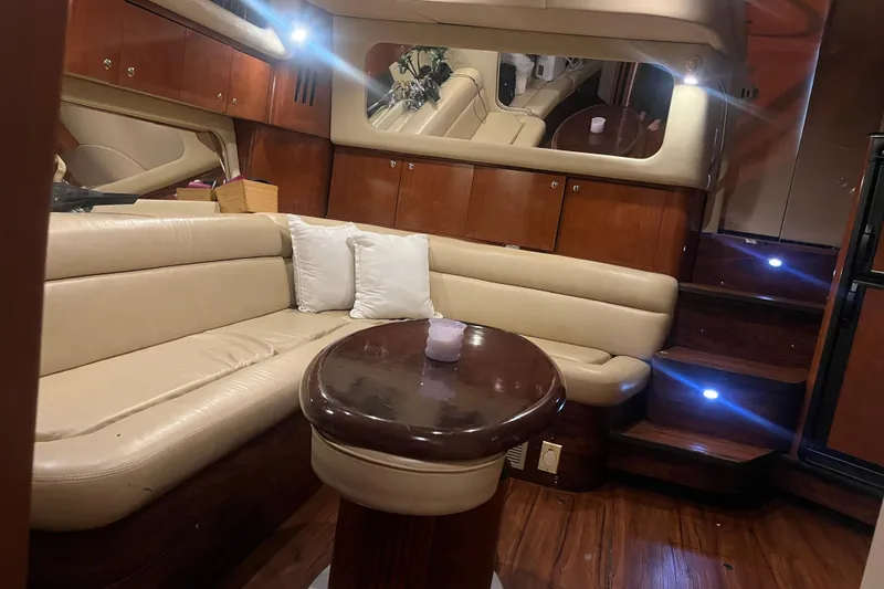 Slide: The Image of Luxurious interior of 2003 Sea Ray 410 Express Cruiser with leather seating and wooden accents. - 11