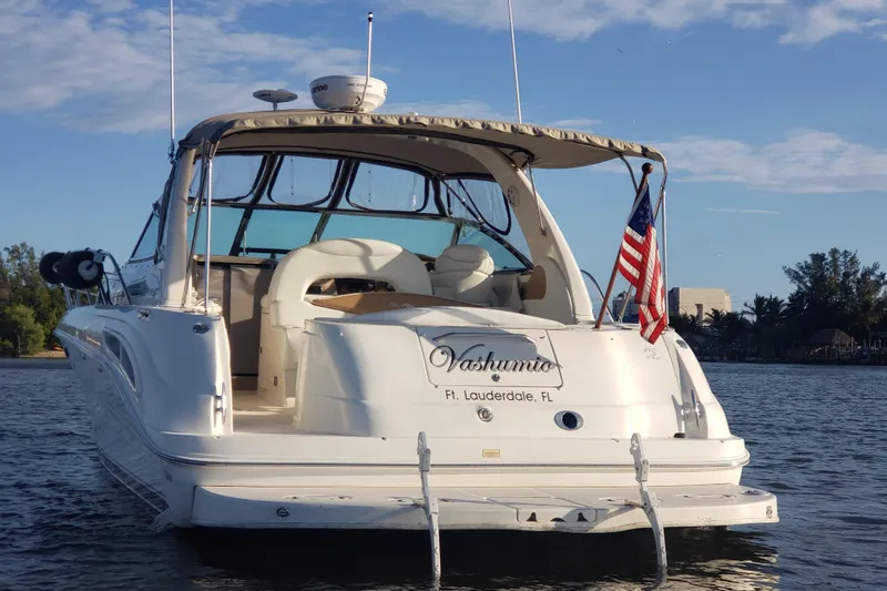 Slide: The Image of 2003 Sea Ray 410 Express Cruiser on water, American flag, Fort Lauderdale. - 4