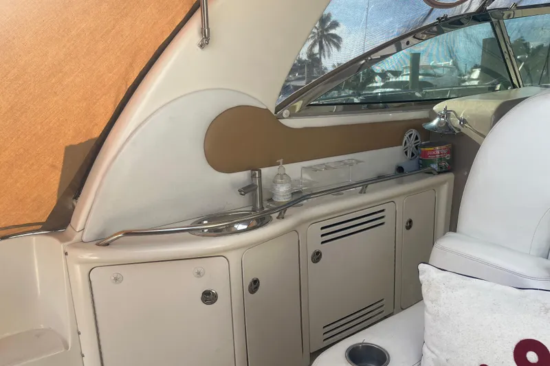 Slide: The Image of 2003 Sea Ray 410 Express Cruiser interior with seating, storage, and window view. - 6