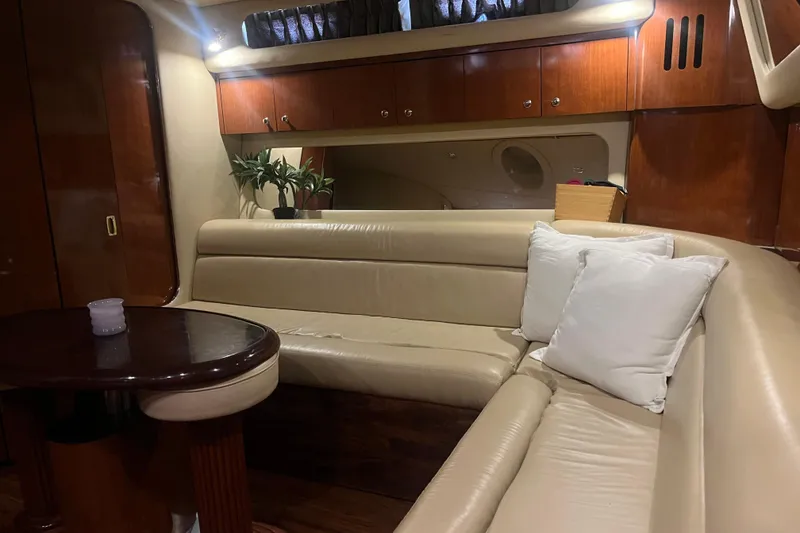 Slide: The Image of Luxurious interior of 2003 Sea Ray 410 Express Cruiser with leather seating and wooden accents. - 9