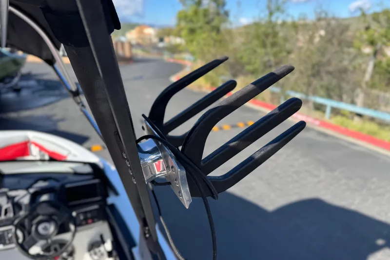 Slide: The Image of 2023 Axis T220 boat with wakeboard rack, steering wheel, and dashboard in view. - 13