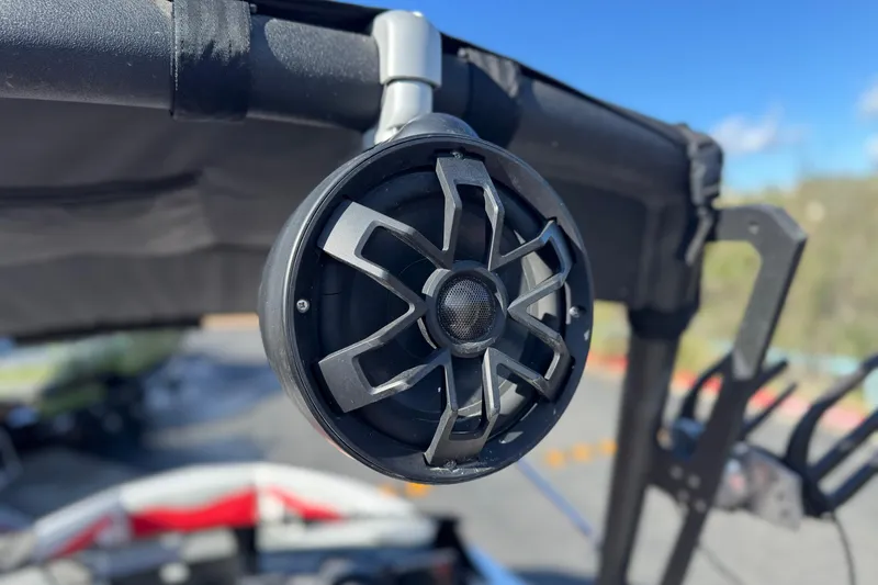 Slide: The Image of 2023 Axis T220 boat speaker mounted on a wakeboard tower, under clear blue sky. - 14