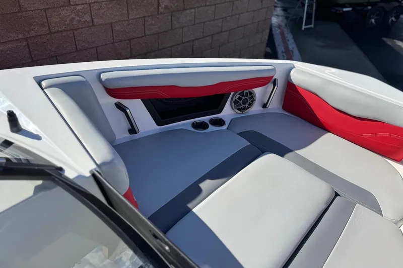 Slide: The Image of 2023 Axis T220 boat interior with red and gray seating, speaker, and cup holders. - 17