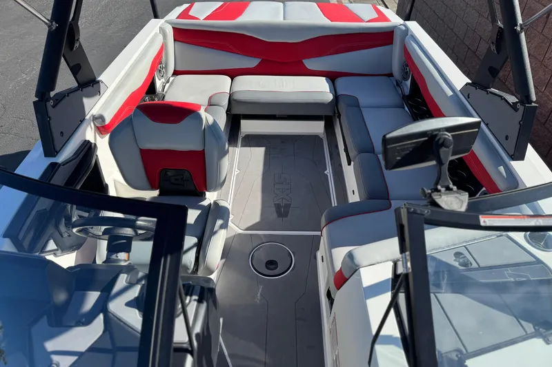Slide: The Image of 2023 Axis T220 boat interior with red and gray seating, modern dashboard, and spacious layout. - 19
