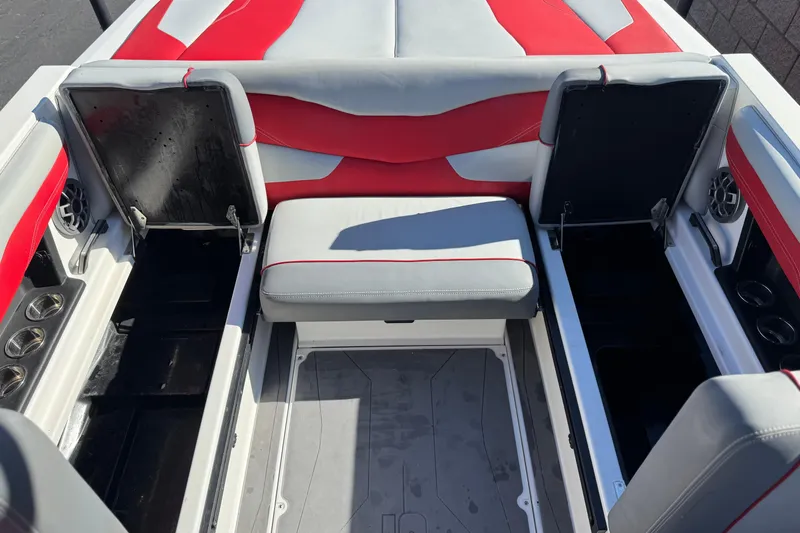 Slide: The Image of 2023 Axis T220 boat interior with red and gray seating, open storage compartments. - 25