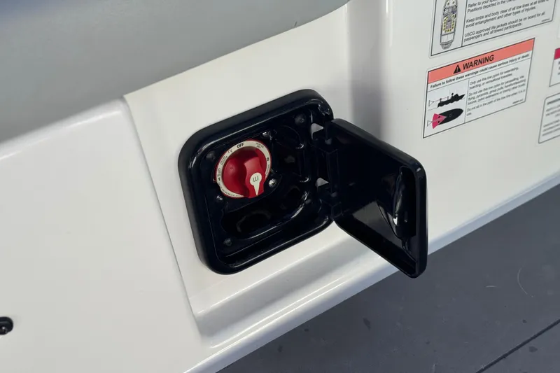 Slide: The Image of 2023 Axis T220 boat battery switch with open cover and warning labels. - 30