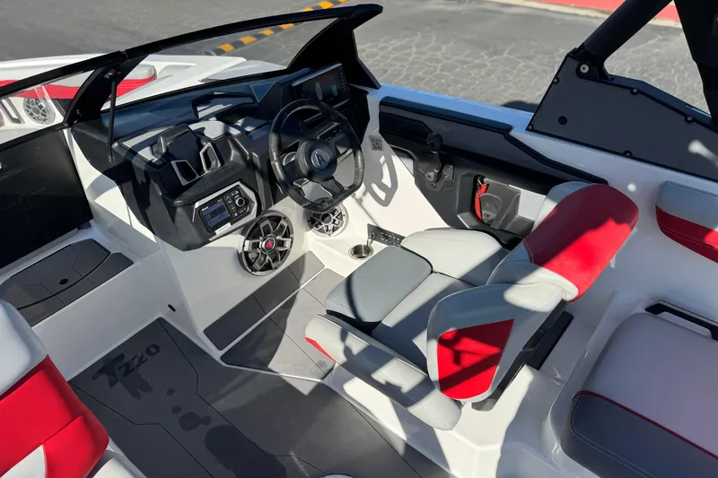 Slide: The Image of 2023 Axis T220 boat interior with modern dashboard and red-accented seating. - 31