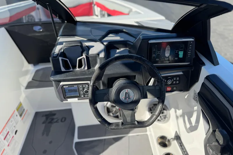 Slide: The Image of 2023 Axis T220 boat dashboard with steering wheel and digital controls. - 32
