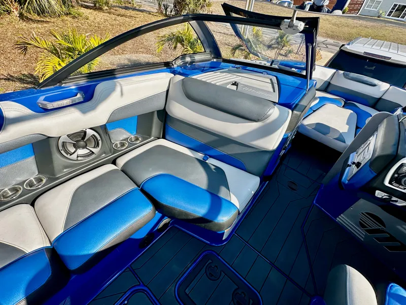 Slide: The Image of Interior of a 2017 Malibu M235 boat with blue and gray seating. - 10
