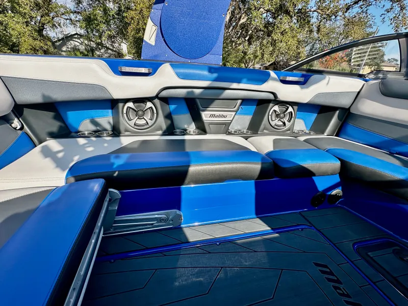 Slide: The Image of Interior of a 2017 Malibu M235 boat with blue and gray seating. - 13