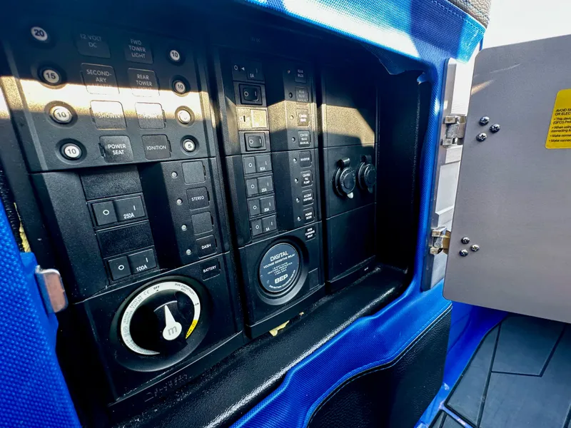 Slide: The Image of Control panel of a 2017 Malibu M235 boat with switches and gauges. - 16