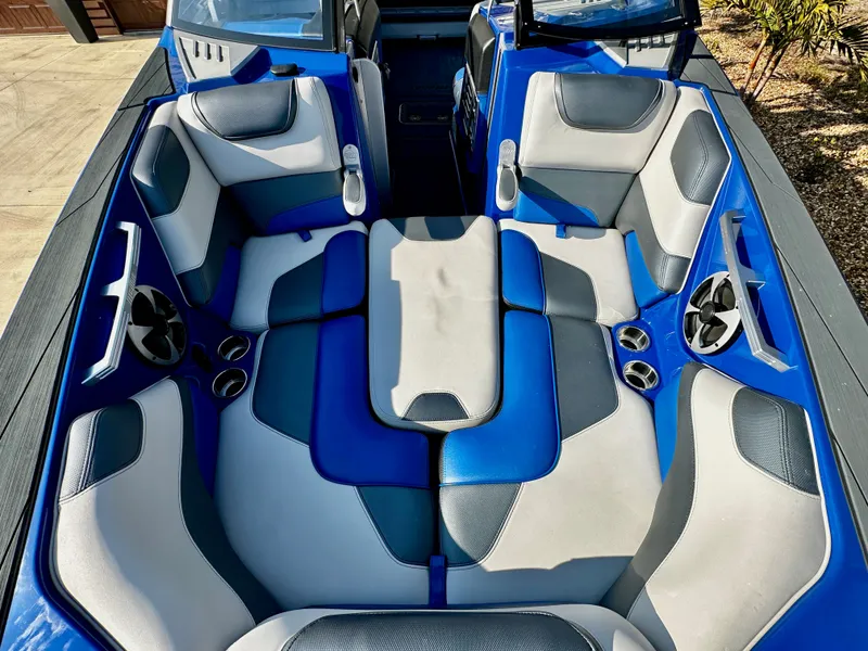 Slide: The Image of Interior of a 2017 Malibu M235 boat with blue and gray seating. - 19