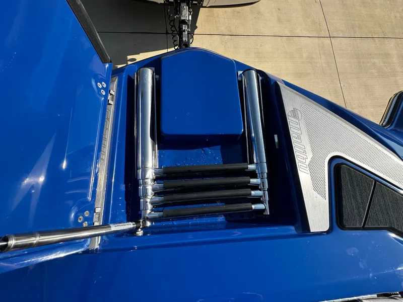 Slide: The Image of Malibu M235 2017 boat rear with blue surface and stainless steel accents. - 20