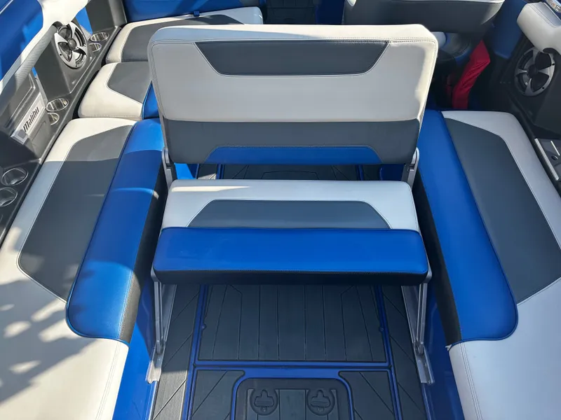 Slide: The Image of Interior of a 2017 Malibu M235 boat with blue and gray seating. - 26
