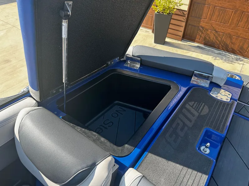 Slide: The Image of Open storage compartment of a 2017 Malibu M235 boat. - 28
