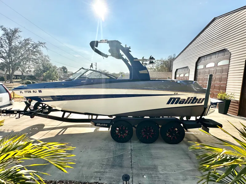 Slide: The Image of 2017 Malibu M235 boat on trailer in sunny driveway. - 3