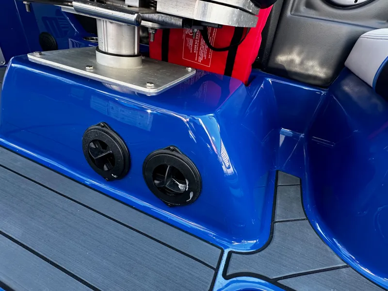 Slide: The Image of Interior of a blue 2017 Malibu M235 boat with speakers. - 33