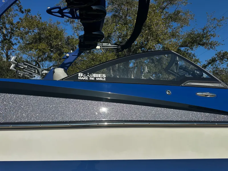 Slide: The Image of 2017 Malibu M235 boat with blue and glittery design. - 38