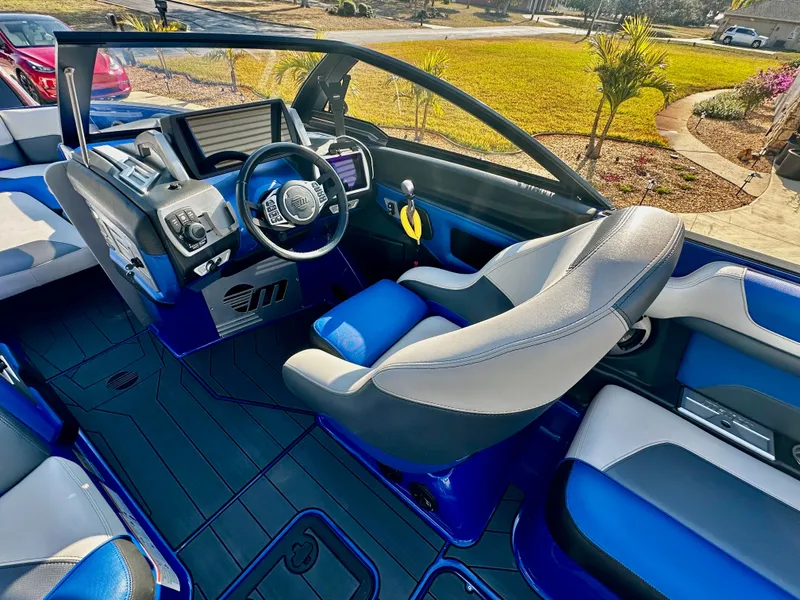 Slide: The Image of Interior of a 2017 Malibu M235 boat with blue and white seating. - 9