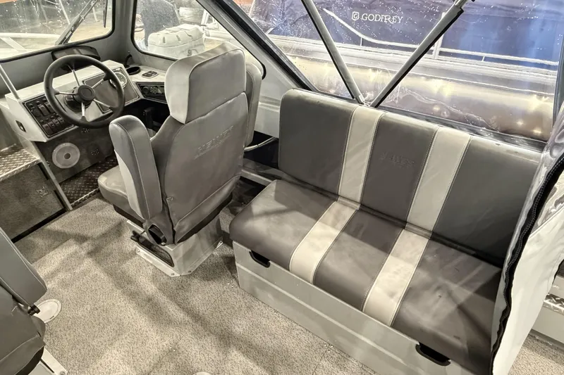Slide: The Image of Interior of 2026 Hewescraft 190 Sea Runner ET, featuring steering wheel and seating. - 11