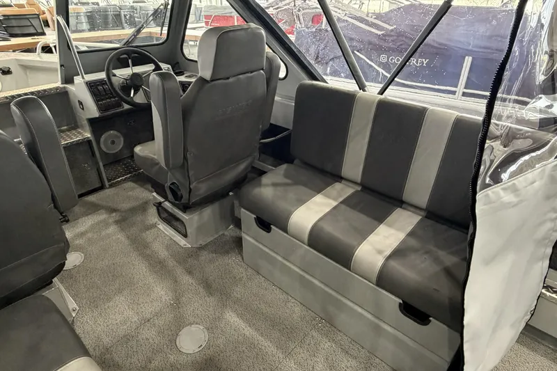 Slide: The Image of Interior of 2026 Hewescraft 190 Sea Runner ET, featuring seating and steering area. - 13
