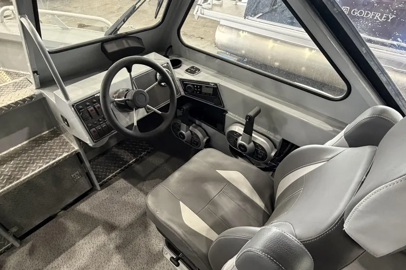 Slide: The Image of Interior of 2026 Hewescraft 190 Sea Runner ET boat, featuring steering wheel and control panel. - 17