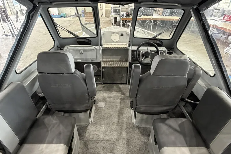 Slide: The Image of Interior of 2026 Hewescraft 190 Sea Runner ET boat, featuring seating and steering console. - 20